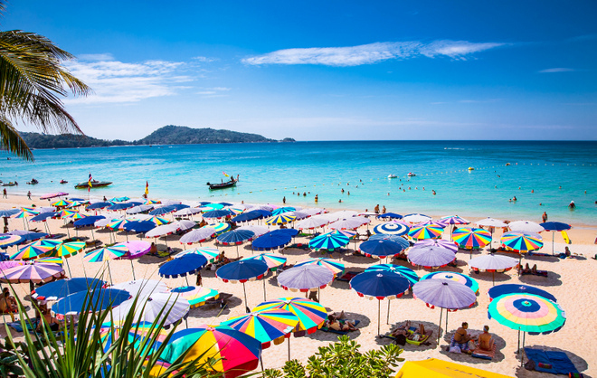 PHUKET, THAILAND- JAN 23, 2016: Crowds of tourists at Patong beach on  Jan 23, 2016 in Phuket, Thailand. Phuket is a popular destination famous for its beaches.